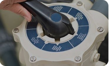 A person using a black and white device to check the wheel.
