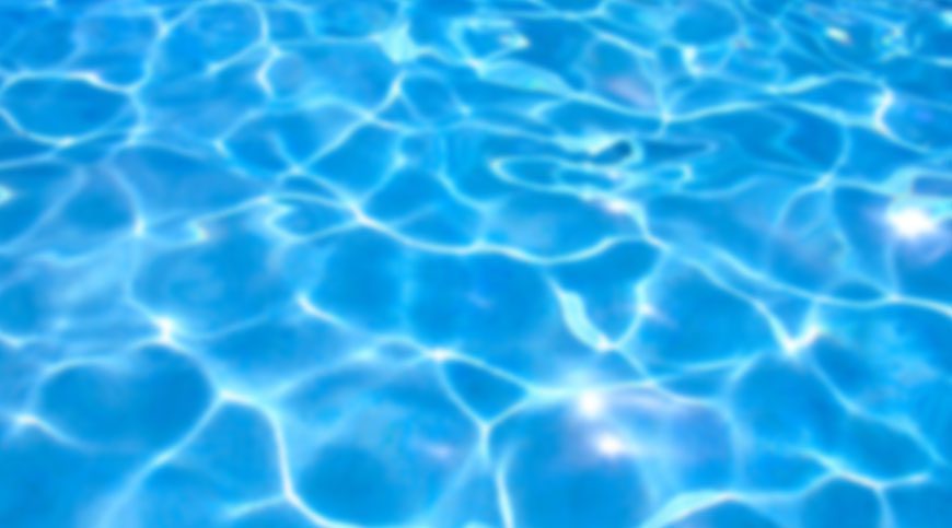 A pool with blue water and ripples.