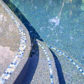 A pool with water and tiles on the ground