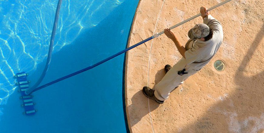 A person holding onto the rope of a pool